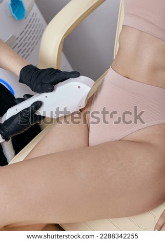 a woman does hair removal in a beauty salon using a laser