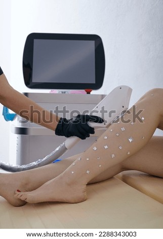 a woman undergoes a laser hair removal procedure in a beauty salon