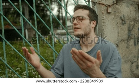 Handsome Tall Muslim Devout Man Praying in Front of a Family Cemetery