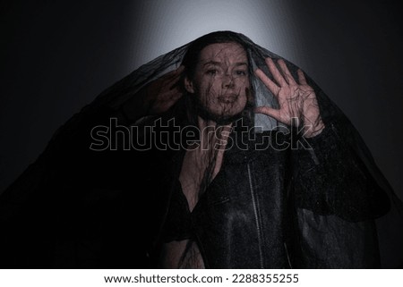a bride witch witch in black clothes with veil