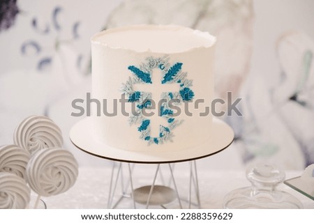 White cake with the image of a cross, a cake for the baptism of a child