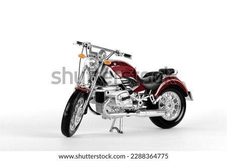 classic red motorcycle with metal and chrome-plated accessories on a white background
