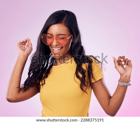 Dancing, sunglasses and cool woman excited, happy and confident isolated in a pink studio background with joy. Singing, music and young genz female dance in celebration of a party energy with glasses Royalty-Free Stock Photo #2288375191