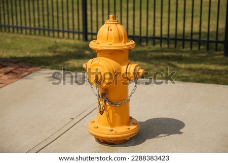 fire hydrant on a street corner, symbolizing the crucial role it plays in ensuring public safety and protecting against the devastating effects of fires Royalty-Free Stock Photo #2288383423