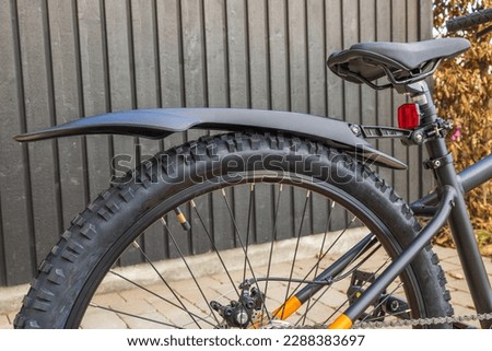 Close-up view of rear wheel of mountain bike with fender. Sweden. Royalty-Free Stock Photo #2288383697