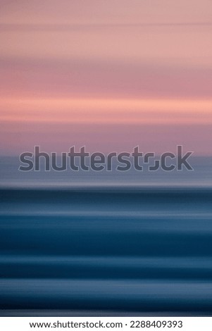 vertical motion blur photography of a beautiful sunset at the beach. mobile wallpaper