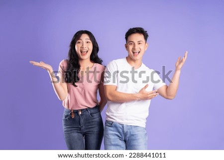 image of asian couple posing on purple background Royalty-Free Stock Photo #2288441011