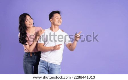 image of asian couple posing on purple background Royalty-Free Stock Photo #2288441013