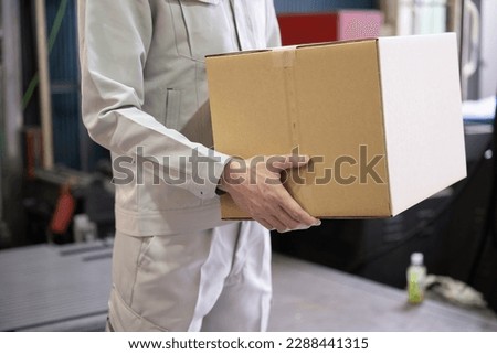 Close-up of the hand of the image of the transportation and delivery industry carrying cardboard boxes Easy to use without a face	 Royalty-Free Stock Photo #2288441315