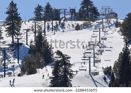 Running Springs, CA USA - January 22, 2023: View of mountain slopes with people skiing and snowboarding at Snow Valley Ski Resort in Running Springs California.