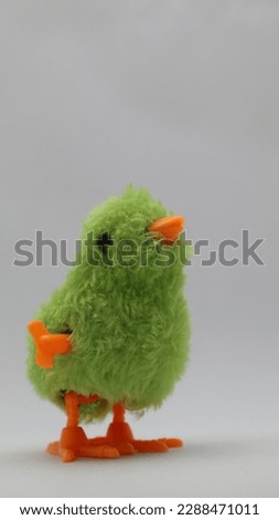walking green chicken toy for kids. little baby chicken toy isolated on white background.