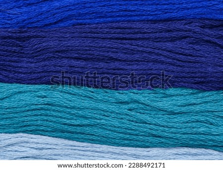 Blue threads - wallpaper with different shades of blue, navy blue. Structure made of strings in different colors.  Textile background