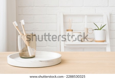 Bamboo toothbrushes in glass on wooden table with copy space Royalty-Free Stock Photo #2288530325