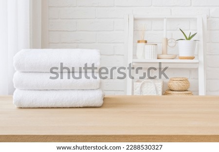 White towel stack on wooden table in bathroom with space Royalty-Free Stock Photo #2288530327