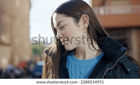 Young caucasian woman smiling confident looking down at street