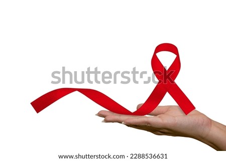 Healthcare and medical, female hand holding red AIDS awareness ribbon. Help red ribbon in support of women's hands for World AIDS Day and National HIV-AIDS Month concept and aging awareness Royalty-Free Stock Photo #2288536631