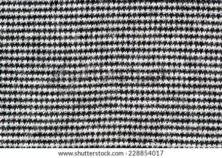 Black and white striped knitting wool texture closeup photo background.