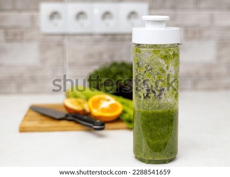 woman do healthy smoothie at kitchen from celery spinach tangerine apple, cutting fruits on board, use blender, drinking and take selfie.female girl in sport suit bright high quality photos