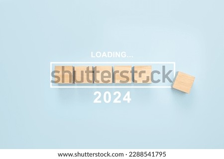 2024 New Year Loading. Loading bar with wooden blocks 2024 on blue background. Start new year 2024 with goal plan, goal concept, action plan, strategy, new year business vision.
