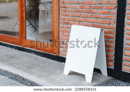 Blank white advertising frame standing mock up on floor with red brick vintage wall. Creative art concept , Empty template. space for text marketing promotion.
