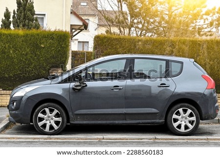 A damaged car with a broken side mirror is parked on the shoulder of the road, and it is necessary to call the insurance company. Royalty-Free Stock Photo #2288560183