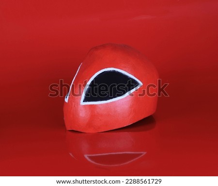 red wrestler mask isolated on red background