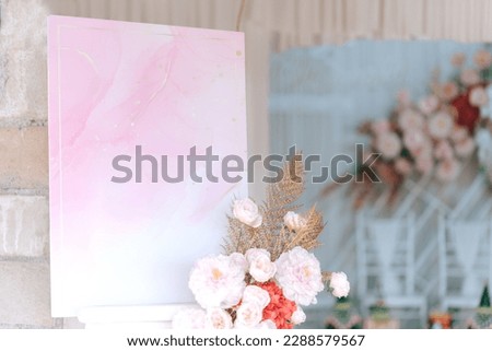 Empty photo display board on stand for wedding arch with flowers background. Copy space for text. Clipping path.