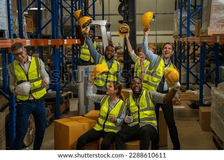 Successful warehouse team smiling happily,Cheerful logistics workers in a large distribution warehouse.