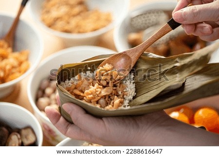 Making zongzi food - preparing and wrapping Chinese rice dumpling at home for Duanwu Dragon Boat Festival celebration, lifestyle.