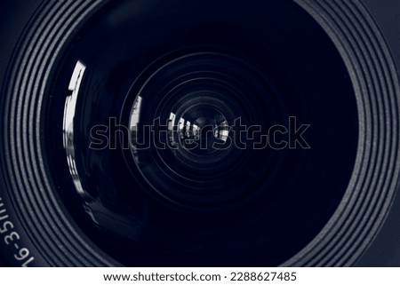macro lens,Photo Camera or Video lens close-up on black background. Objective. Work photographer concept. Photographer looking. Photographer. Journalist. Videographer working black and white.