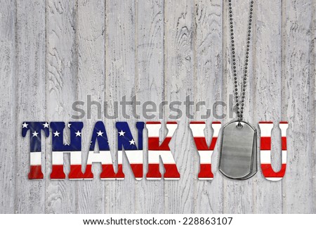 military dog tag thank you with flag font on weathered barn wood background  Royalty-Free Stock Photo #228863107