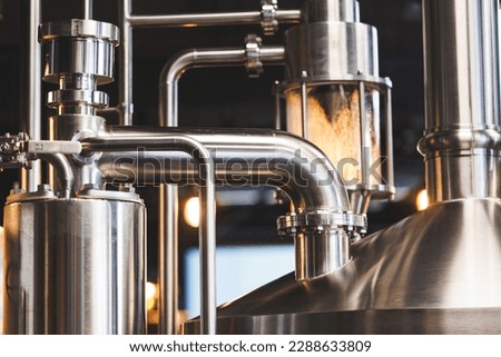 Beer brewing . Commercial brewing equipment close up shot. Industrial beer brewing stainless pipe Royalty-Free Stock Photo #2288633809