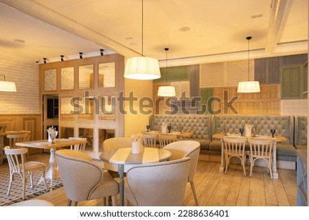 Stylish interior of a cozy restaurant. Modern Interior design in light colors Royalty-Free Stock Photo #2288636401
