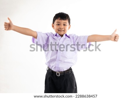 Excited happy smilling boy thumb up. Thai school uniform with backpack bag. Portrait Young Asian cute boy standing on white background banner. Back to school.