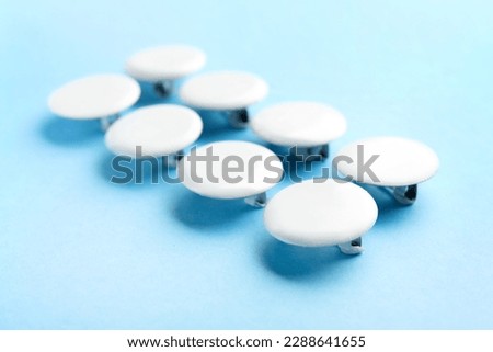 Blank white badges on blue background
