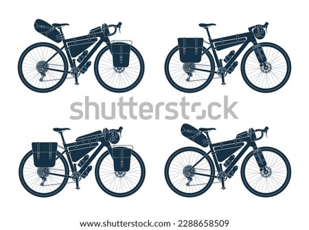 Set of touring bikes with bikepacking bags in black silhouette. Road, gravel bicycle and elements gear. Saddlebag, frame, trunk, handlebar bag. Collection isolated vector illustration Royalty-Free Stock Photo #2288658509
