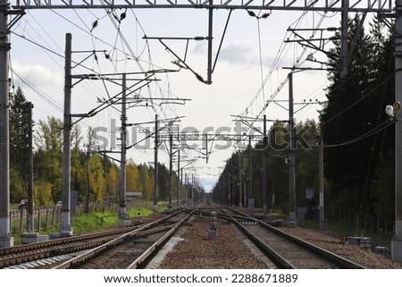 The way forward railway. Train track on autumn landscape.