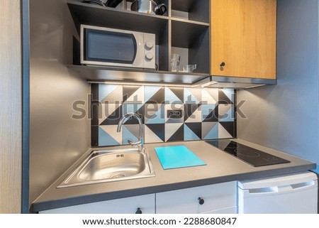 Small modern kitchen in student dorm. Hostel dormitory room. Campus  Royalty-Free Stock Photo #2288680847