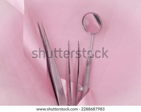 Equipment for eyelash extensions in beauty salon on pink background .High quality photo