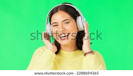 Face, green screen and woman with headphones, dance and music streaming against a studio background. Portrait, female and person with headset, listening to audio and sounds for movement and smile