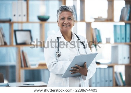 Senior woman doctor, portrait and checklist in clinic for inspection, healthcare paperwork or report. Female medic, clipboard and documents for results, analysis or diagnosis with smile at hospital Royalty-Free Stock Photo #2288694403