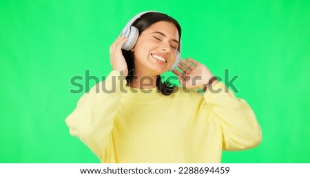 Face, green screen and woman with headphones, listen and movement on a studio background. Portrait, female dancer and person with headset, streaming music and excitement with stress relief and relax
