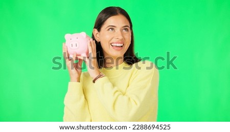 Happy woman, money and savings on green screen for investment, budget or finance against studio background. Portrait of excited female smile holding piggybank for coin, profit or investing on mockup