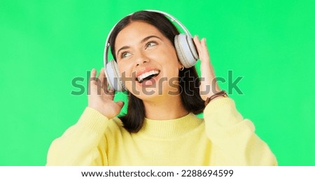 Face, green screen and woman with headphones, dance and music streaming against a studio background. Portrait, female and person with headset, listening to audio and sounds for movement and smile