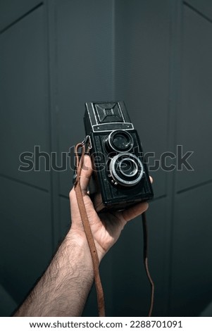 Hand hold vintage medium format camnera camera isolated on black background