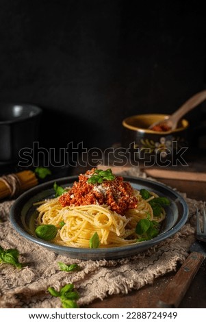 Delicious pasta with basil, parmesan cheese and bolognese sauce