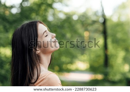 Ways To Unplug From Technology and Be Present. Unplugging from Technology and Living a More Mindful Life. Outdoor portrait of young woman enjoying nature Royalty-Free Stock Photo #2288730623
