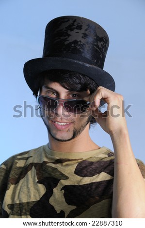 Portrait of trendy young man posing with a hat