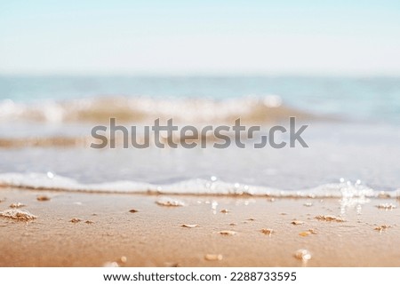Closeup of sand on beach and blue summer sky. Panoramic beach landscape. Empty tropical beach and seascape.