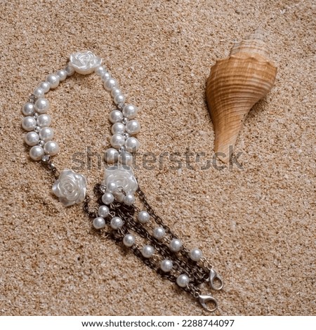 Closeup picture of buried bracelet on the sand beach